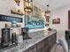 Convenient coffee bar with speckled granite countertop, storage cabinets and stylish decor at 2005 Via Firenze, Henderson, NV 89044