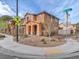 Corner lot home with desert landscaping, sidewalks, and street signs on a sunny day at 2005 Via Firenze, Henderson, NV 89044
