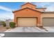 Exterior view of the home with a large attached garage and well maintained landscaping at 2005 Via Firenze, Henderson, NV 89044