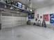 Spacious garage with epoxy flooring, overhead storage racks, and sports memorabilia at 2005 Via Firenze, Henderson, NV 89044