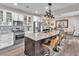 Modern kitchen with stainless steel appliances, a spacious island, and stylish pendant lighting at 2005 Via Firenze, Henderson, NV 89044