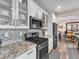 Updated kitchen showcasing stainless steel appliances, mosaic backsplash, and granite countertops at 2005 Via Firenze, Henderson, NV 89044
