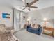 Comfortable living room with a ceiling fan, large window, and inviting furniture at 2005 Via Firenze, Henderson, NV 89044