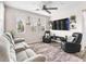 Inviting living room features ceiling fan, mounted TV, and plush seating with ample windows at 2005 Via Firenze, Henderson, NV 89044
