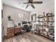 Functional office space with desk, shelving unit, neutral walls, and wood-look flooring at 2005 Via Firenze, Henderson, NV 89044