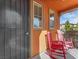 Charming front porch with red rocking chairs providing a welcoming entrance to the home at 2005 Via Firenze, Henderson, NV 89044