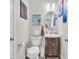Charming powder room with vanity, oval mirror and decorative artwork at 2005 Via Firenze, Henderson, NV 89044