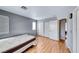 Bedroom featuring wood floors, a sliding door closet, and a window with natural light at 2029 Rose Coral Ave, Las Vegas, NV 89106