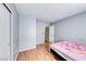 Bright bedroom featuring wood floors, neutral paint, and closet storage at 2029 Rose Coral Ave, Las Vegas, NV 89106