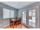 Dining area with light gray walls, wood flooring, and access to the backyard through french doors at 2029 Rose Coral Ave, Las Vegas, NV 89106