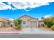 Single story home with a neutral colored stucco exterior, desert landscaping, and an attached single car garage at 2029 Rose Coral Ave, Las Vegas, NV 89106