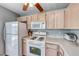 Cozy kitchen with white appliances, cabinets, countertops, and a ceiling fan at 2029 Rose Coral Ave, Las Vegas, NV 89106