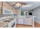 Kitchen with light gray walls, wood flooring, white appliances, a ceiling fan, and a skylight at 2029 Rose Coral Ave, Las Vegas, NV 89106