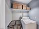 Laundry room with front load washer and storage shelves for organization at 2029 Rose Coral Ave, Las Vegas, NV 89106