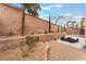 Private backyard featuring desert landscaping, mature trees, and ample space for outdoor seating at 2057 Wandering Doe Ln, Las Vegas, NV 89134