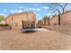 Large backyard provides space for activities with a trampoline, covered patio, and ample space for outdoor living at 2057 Wandering Doe Ln, Las Vegas, NV 89134
