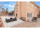 Expansive backyard featuring a concrete patio area, lounging furniture, and ample space for outdoor activities at 2057 Wandering Doe Ln, Las Vegas, NV 89134