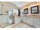 Elegant bathroom featuring a large soaking tub, dual vanities, a walk-in shower, and stylish fixtures at 2057 Wandering Doe Ln, Las Vegas, NV 89134