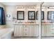 Beautiful bathroom boasts dual sinks, granite countertops, stylish mirrors, and modern lighting fixtures at 2057 Wandering Doe Ln, Las Vegas, NV 89134