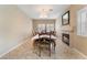 Formal dining room with fireplace, decorative lighting, and tiled floor at 2057 Wandering Doe Ln, Las Vegas, NV 89134