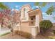 Exterior view of a two-story home with desert landscaping and a tile roof at 2057 Wandering Doe Ln, Las Vegas, NV 89134