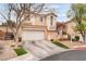 Two-story home with a two-car garage, desert landscaping, and a tile roof at 2057 Wandering Doe Ln, Las Vegas, NV 89134