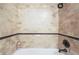 The shower boasts decorative tilework, a rainfall showerhead, and built-in storage niches at 2057 Wandering Doe Ln, Las Vegas, NV 89134