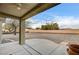 Expansive backyard featuring a covered patio with ceiling fan and low-maintenance gravel landscaping at 2516 Evansville Ave, Henderson, NV 89052