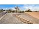 Large backyard with gravel landscaping and a retaining wall feature; low maintenance and ready for customization at 2516 Evansville Ave, Henderson, NV 89052