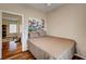 Cozy bedroom with an exterior view painting with hard wood floors and nice lighting at 2516 Evansville Ave, Henderson, NV 89052