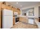 The bright kitchen features oak cabinetry, modern appliances and tile flooring at 2516 Evansville Ave, Henderson, NV 89052