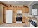 Bright kitchen features oak cabinetry, granite counters and mosaic tile backsplash at 2516 Evansville Ave, Henderson, NV 89052