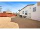 Gravel backyard with a view of the exterior, seating area, and privacy fence at 274 Aztec Ln, Henderson, NV 89015