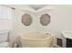 A relaxing bathroom with a corner soaking tub and unique window design at 274 Aztec Ln, Henderson, NV 89015