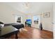 Bedroom with wood floors, ceiling fan, and a TV at 274 Aztec Ln, Henderson, NV 89015