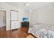 Bright bedroom with a four-poster bed and hardwood floors at 274 Aztec Ln, Henderson, NV 89015