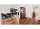 Dining area featuring modern kitchen with dark cabinetry and hardwood flooring at 274 Aztec Ln, Henderson, NV 89015