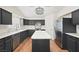 Modern kitchen features black cabinetry, stainless steel appliances, and a center island at 274 Aztec Ln, Henderson, NV 89015