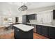 Well-lit kitchen and dining area featuring dark wood cabinets and flooring at 274 Aztec Ln, Henderson, NV 89015