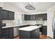 Bright kitchen boasts sleek black cabinets, stainless appliances, and center island at 274 Aztec Ln, Henderson, NV 89015