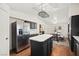 Open kitchen and dining area with stainless steel refrigerator and center island at 274 Aztec Ln, Henderson, NV 89015