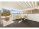 Charming covered patio featuring a fire pit and seating, creating an ideal spot for outdoor enjoyment at 274 Aztec Ln, Henderson, NV 89015