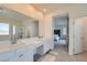 Spacious bathroom featuring a double vanity, large mirror, and ensuite bedroom access at 290 Mount Tyndall St, Henderson, NV 89015