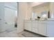 Bright bathroom with a double sink vanity, large mirror, tile flooring, and a separate shower and tub at 290 Mount Tyndall St, Henderson, NV 89015