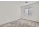 Bright bedroom features neutral carpet, white walls and a window to allow for ample natural light at 290 Mount Tyndall St, Henderson, NV 89015