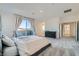 Large bedroom with carpet, dark dresser, balcony, and ensuite bathroom access at 290 Mount Tyndall St, Henderson, NV 89015