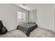This bedroom features plush carpet, a guitar, a comfortable bed, and a window with blinds at 290 Mount Tyndall St, Henderson, NV 89015