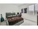 Cozy bedroom with carpet, window with blinds, guitar, gaming system, and a comfortable gray bed at 290 Mount Tyndall St, Henderson, NV 89015
