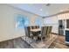 Bright dining room with modern table, seating for eight, and view to the kitchen at 290 Mount Tyndall St, Henderson, NV 89015