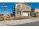 Charming two-story home featuring stone accents, a two-car garage, and landscaped front yard at 290 Mount Tyndall St, Henderson, NV 89015